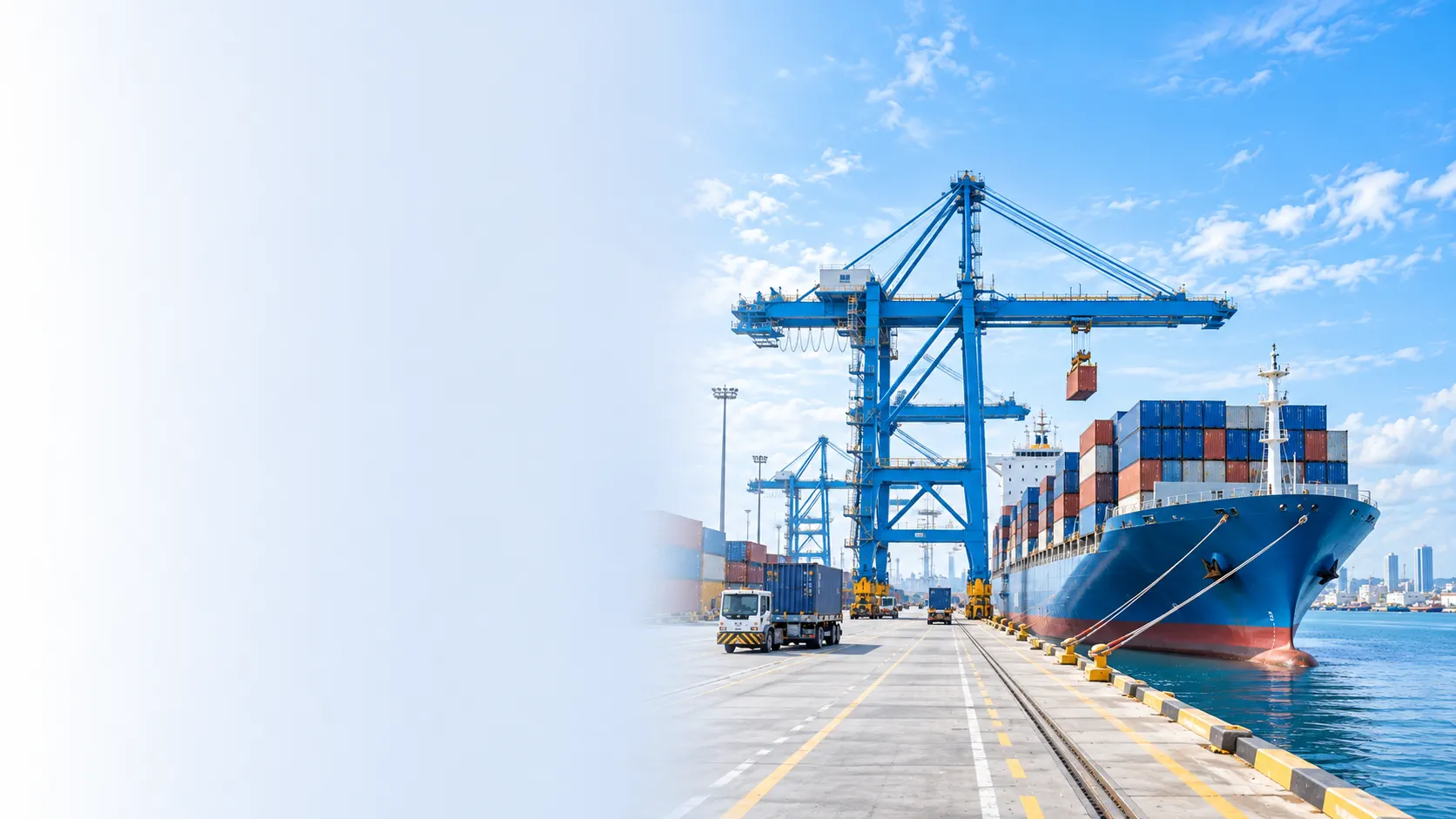 Container ship alongside blue cranes and cargo vehicles at a bright port terminal
